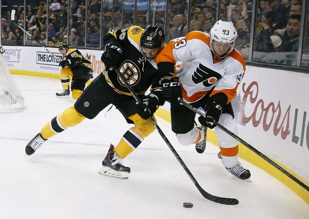 Boston Bruins' Tommy Cross (56) and Philadelphia Flyers' Jakub Voracek (93) battle for the puck during the third period of the game at TD Garden yesterday. (Michael Dwyer/AP)