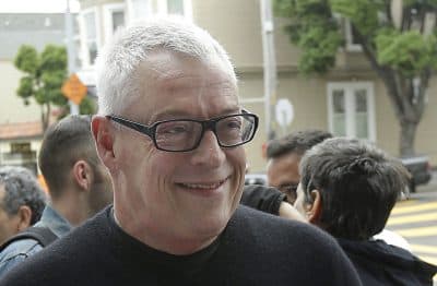 Activist Cleve Jones smiles outside of a U.S. Post Office as customers buy commemorative stamps honoring Harvey Milk, the California politician and gay rights icon, at a U.S. Post Office in San Francisco, Thursday, May 22, 2014. (Jeff Chiu/AP)