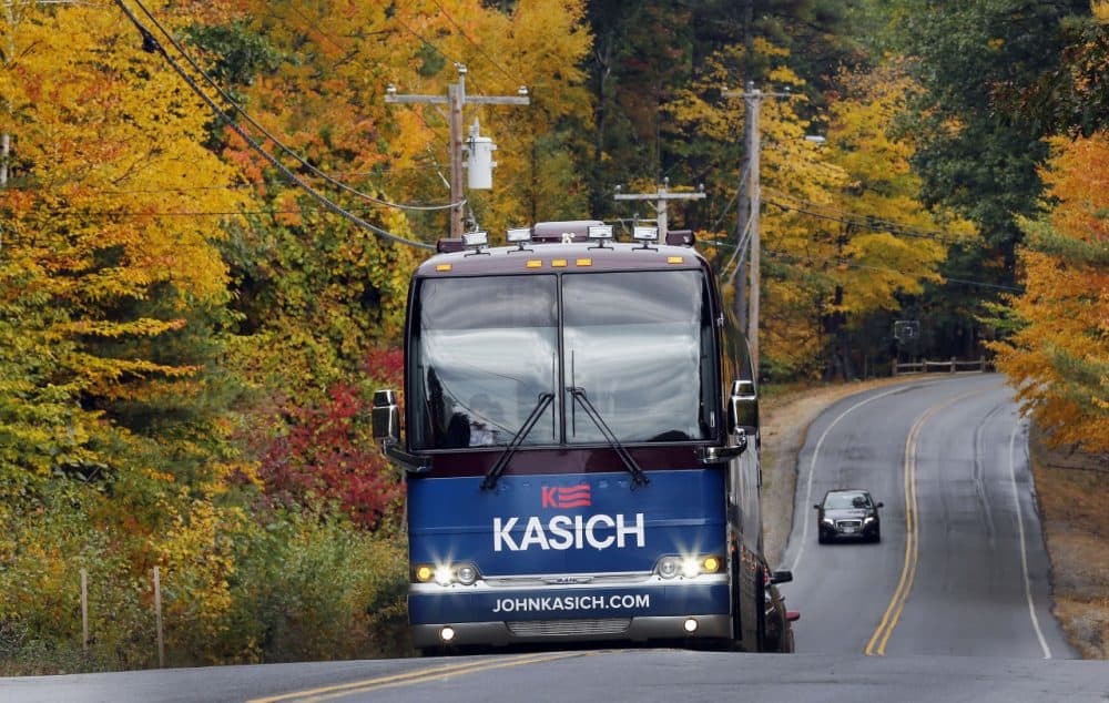 Republican presidential candidate, Ohio Gov. John Kasich rides through the fall colors in his bus as he campaigns in the nation's earliest presidential primary state. (Jim Cole/AP)