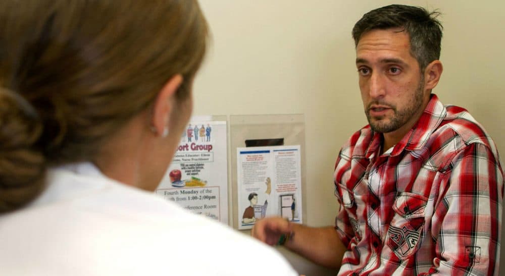 Some medical professionals express frustration that patients struggling with addiction are not always treated as though they suffer from a chronic illness. In this photo, Michael Cavallo meets with Dr. Sarah Wakeman to discuss the challenges he faces in his more than 20-year battle against addiction, August 2015. (Hadley Green for WBUR)