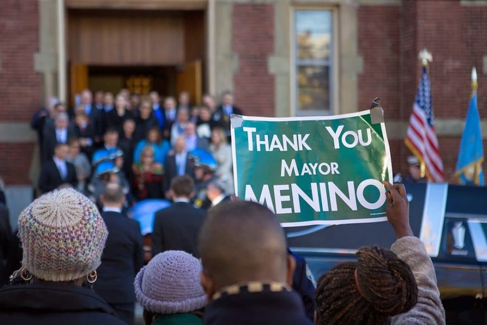 A woman holds up a sign reading “Thank You Mayor Menino” outside the church where his funeral was held on Nov. 3, 2014. (Jesse Costa/WBUR)

