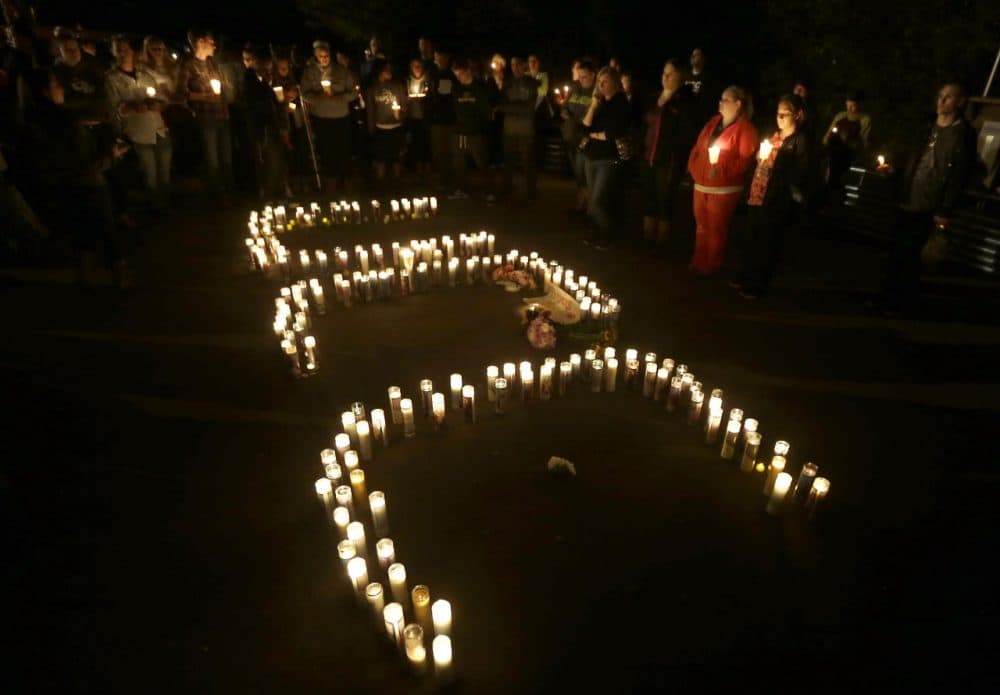 Candles spelling UCC -- for Umpqua Community College -- are displayed at a candlelight vigil for those killed during a fatal shooting at the school, Thursday in Roseburg, Oregon. (Rich Pedroncelli/AP)