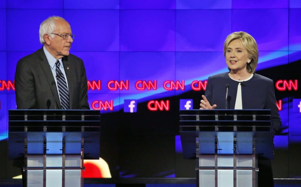 A new WBUR poll of likely Democratic primary voters finds Hillary Clinton edging ahead of Bernie Sanders in New Hampshire. Here are Clinton and Sanders during the Oct. 13 Democratic debate in Las Vegas. (John Locher/AP)