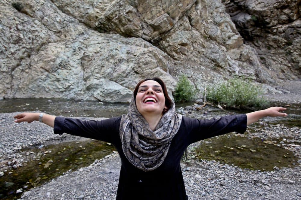 An unidentified Iranian woman practices in an outdoor session of a Laughter Yoga class (AP Photo/Vahid Salemi)
