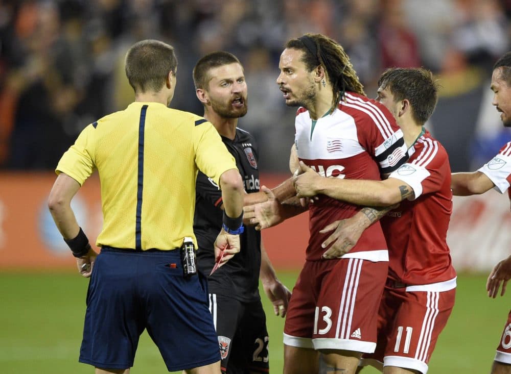 Revolution midfielder Jermaine Jones (13) is restrained after he was given a red card and ejected during the second half of an MLS playoff game Wednesday in Washington. D.C. United won 2-1. (Nick Wass/AP)