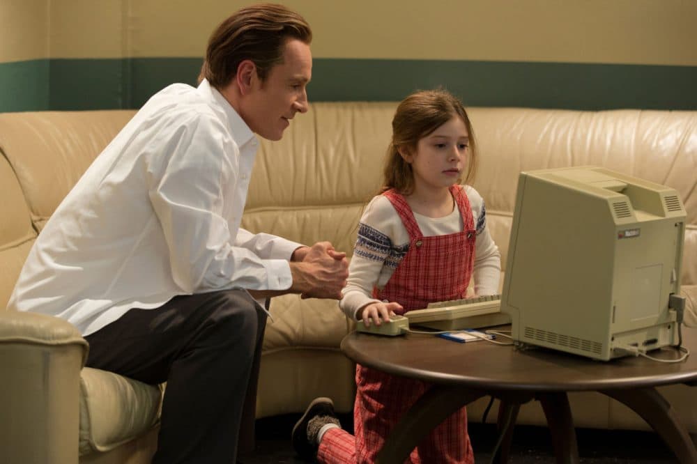 Michael Fassbender, left, as Steve Jobs and Makenzie Moss as a young Lisa Jobs, appear in a scene from the film, &quot;Steve Jobs.&quot; The movie releases in the U.S. on Friday, Oct. 9, 2015. (Francois Duhamel/Universal Pictures via AP)