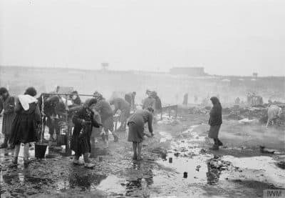 Women scavenge for food in this photograph taken during the liberation of Bergen-Belsen in 1945. (© IWM, BU 3745)