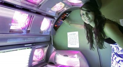 A 17-year-old -- who has been using tanning beds since she was 14 -- prepares a tanning bed for a session, Wednesday, March 25, 2009, in Tallahassee, Fla.  The Massachusetts House is now considering a bill to ban tanning bed use by minors. (Phil Coale/AP)