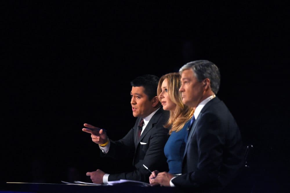 Debate moderators Carl Quintanilla, left, Becky Quick, center, and John Harwood appear during the CNBC Republican presidential debate at the University of Colorado, Wednesday, Oct. 28, 2015, in Boulder, Colo.  (AP)