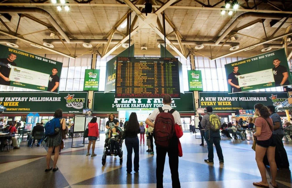 Advertisements for the online fantasy sports compant DraftKings, based in Boston, hang in South Station.  (WBUR)
