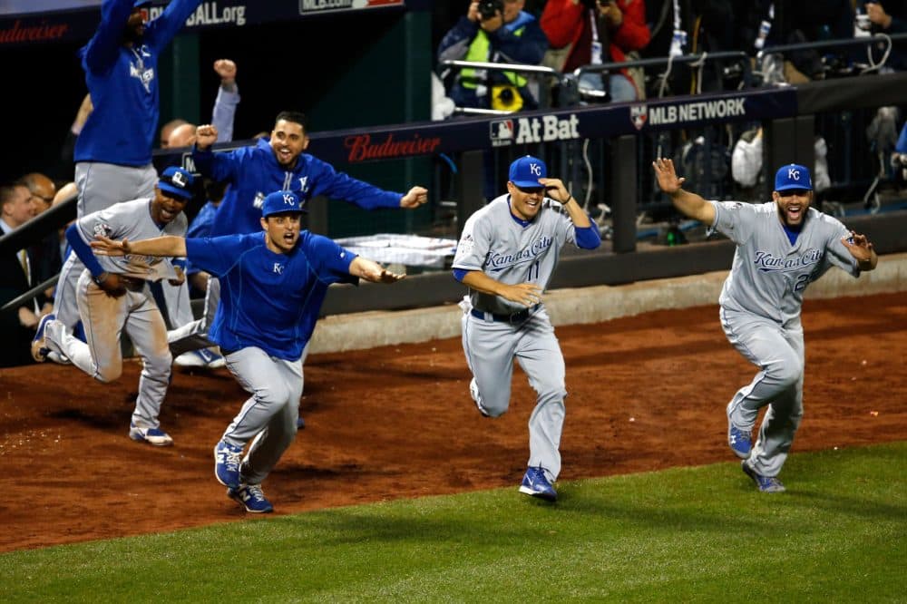 The Kansas City Royals dugout runs onto the field to celebrate defeating the New York Mets in Game Five of the 2015 World Series.  (Sean M. Haffey/Getty Images)