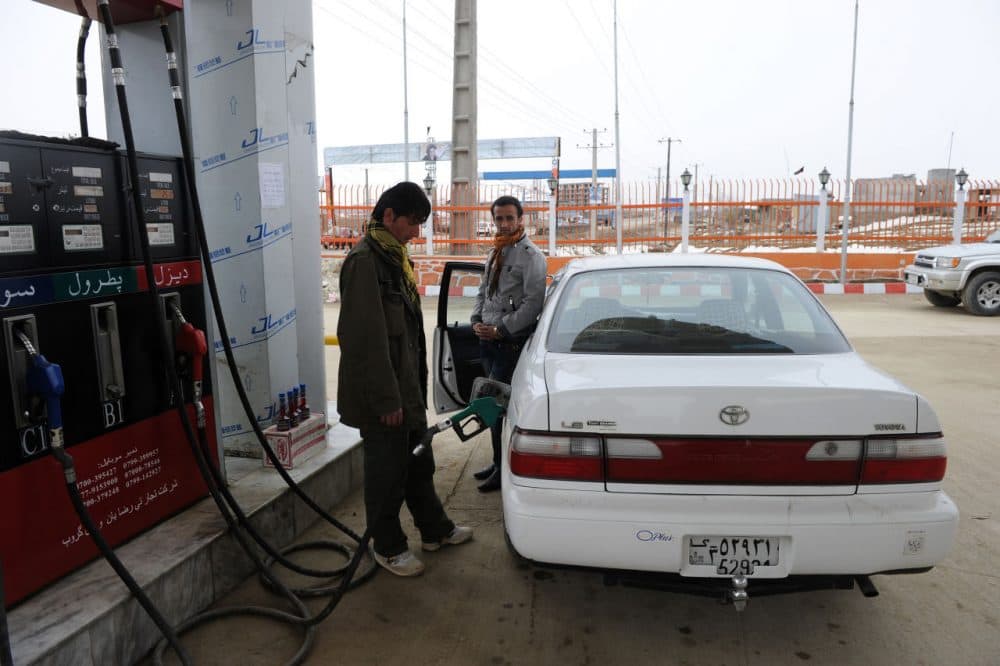 A petrol station employee fills up the tank of a car at a fuel station in the Shomali Plain, some 20 kilometers north of Kabul in Afghanistan on February 22, 2011. (Shah Marai/AFP/Getty Images)