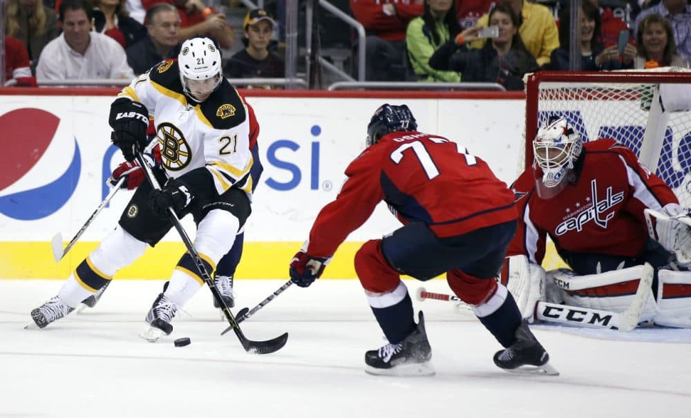 Boston Bruins left wing Loui Eriksson (21), from Sweden, has the puck knocked away by Washington Capitals right wing T.J. Oshie (77) with goalie Braden Holtby (70) during the game yesterday. The Capitals won 4-1. (Alex Brandon/AP)