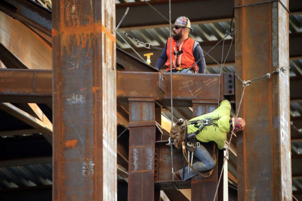 Iron workers help to build the new Comcast Innovation and Technology Center under construction, Friday, Oct. 23, 2015, in Philadelphia. (Matt Rourke/AP)