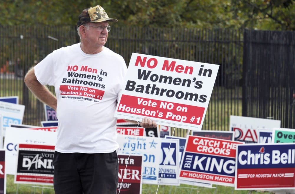 In this Oct. 21, 2015 photo, a man urges people to vote against the Houston Equal Rights Ordinance outside an early voting center in Houston. On Tuesday, Nov. 3, 2015, voters statewide can give themselves tax breaks, pump billions of dollars into roads and make hunting and fishing constitutional rights by supporting seven amendments to the Texas Constitution on Tuesday's ballot. And Houston will choose a new mayor and decide whether to extend nondiscrimination protections to its gay and transgender residents in a referendum being watched nationally. (Pat Sullivan/AP)