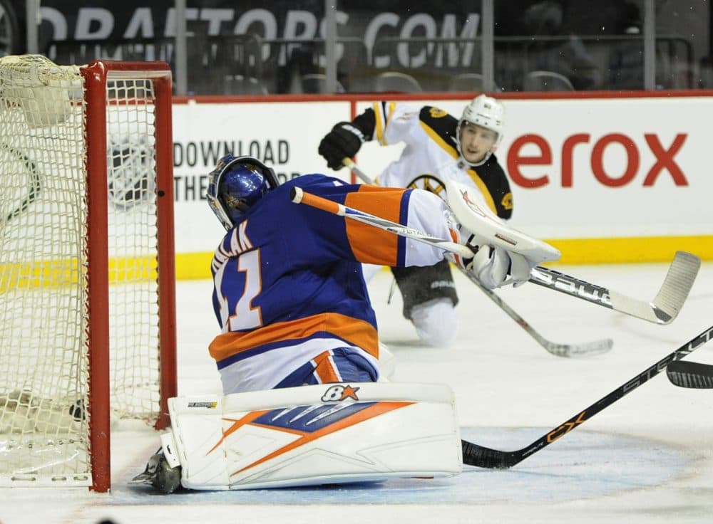 Boston Bruins' Ryan Spooner shoots the puck past New York Islanders goalie Jaroslav Halak (41) to score during the first period of the game last night. (Kathy Kmonicek/AP)