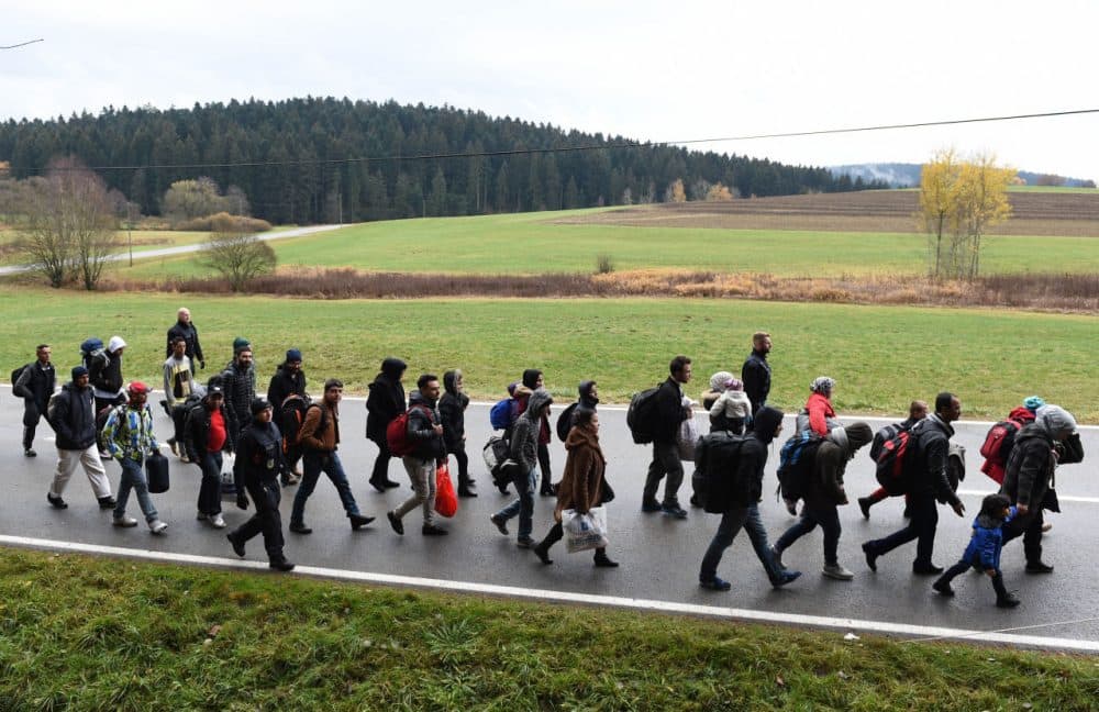 Migrants walk on the road after crossing the Austrian-German border near the Bavarian village of Wegscheid, southern Germany, on November 9, 2015. (Christof Stache/AFP/Getty Images)