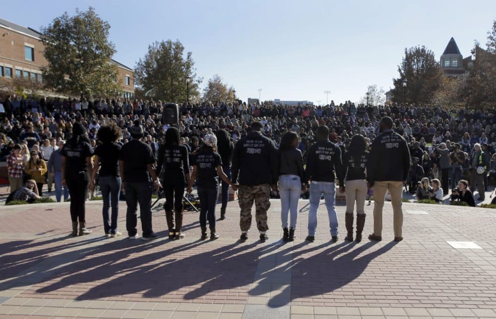 Members of black student protest group Concerned Student 1950 hold hands following the announcement that University of Missouri System President Tim Wolfe would resign Monday, Nov. 9, 2015, at the university in Columbia, Mo. Wolfe resigned Monday with the football team and others on campus in open revolt over his handling of racial tensions at the school. (Jeff Roberson/AP)