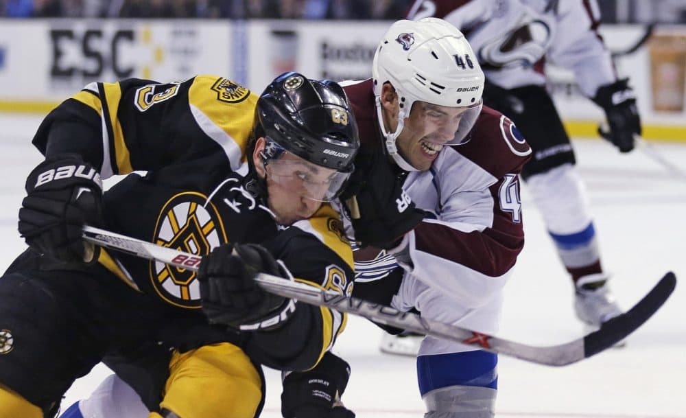 Bruins left wing Brad Marchand, left, and Colorado Avalanche defenseman Brandon Gormley, right, skate after the puck during the second period of a game in Boston, Thursday, Nov. 12, 2015. (Charles Krupa/AP)