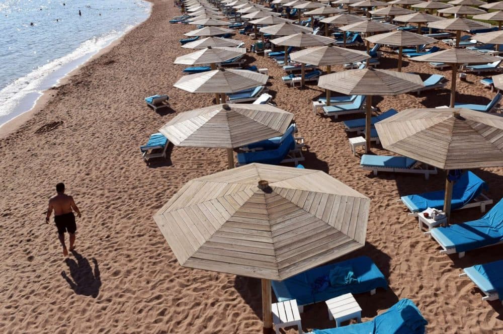 A tourist walks past sunbeds on a beach in Egypt's Red Sea resort of Sharm El-Sheikh on November 10, 2015. As visitors stranded after the crash of a Russian airliner stream home from Egypt, Sharm El-Sheikh is scrambling to keep its lucrative tourism sector alive. (Mohamed el-Shahed/AFP/Getty Images)
