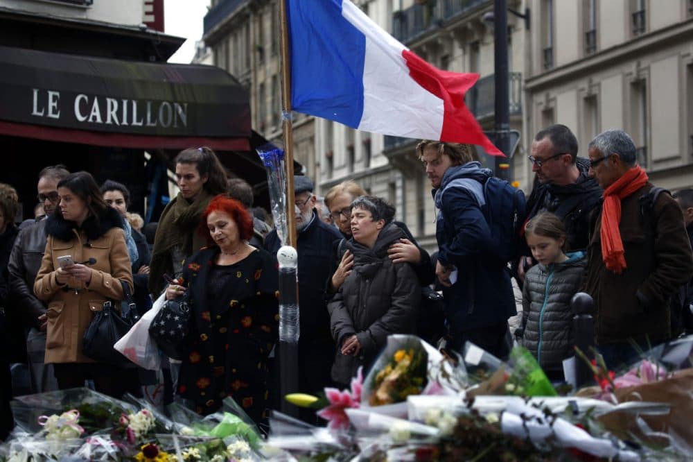 People gather in front of Le Carillon cafe, a site of the recent attacks in Paris. (Jerome Delay/AP)