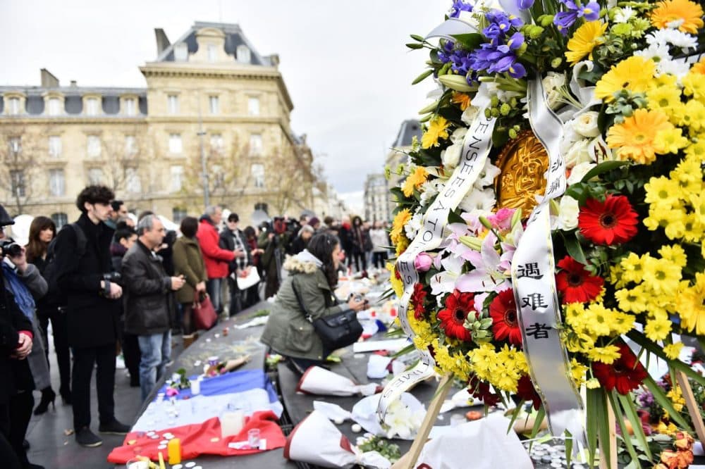 People take part in a gathering at a makeshift memorial for the victims of the attacks claimed by Islamic State, on November 16, 2015 at the Place de la Republique in Paris. France and other countries in Europe held a minute's silence in memory of the victims of the worst ever terror attacks on French soil. (Loic Venance/AFP/Getty Images)