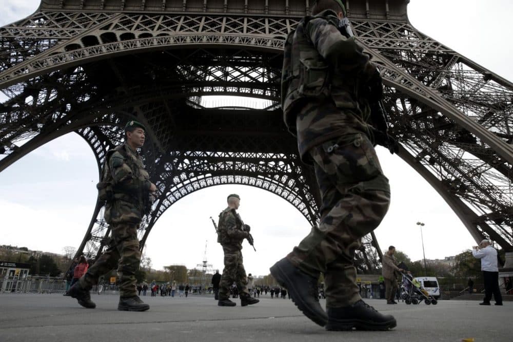 Soldiers patrol at the foot of the Eiffel Tower in Paris on November 16, 2015 three days after the terrorist attacks that left at least 129 dead and more than 350 injured. France prepared to fall silent at noon on November 16 to mourn victims of the Paris attacks after its warplanes pounded the Syrian stronghold of Islamic State, the jihadist group that has claimed responsibility for the slaughter. (Kenzo Tribouillard/AFP/Getty Images)