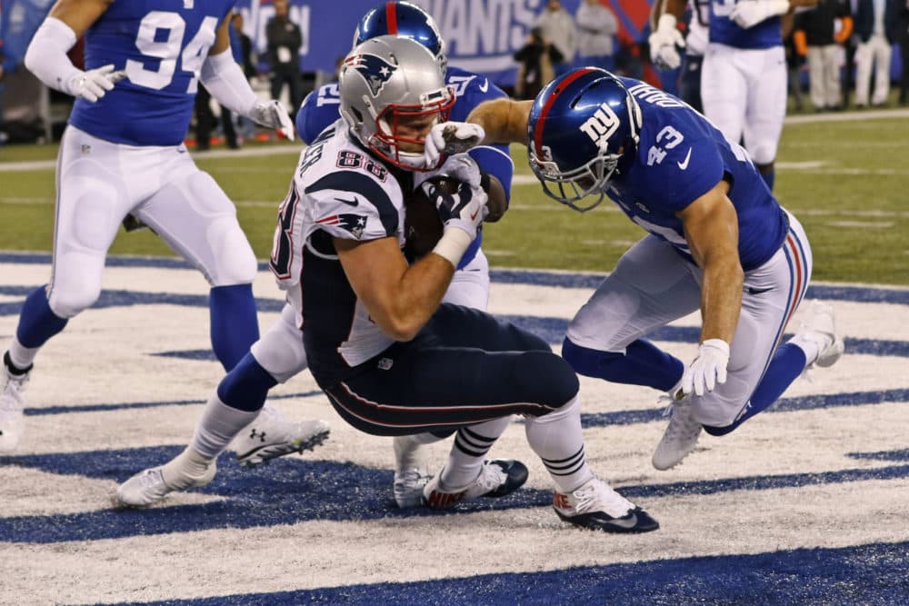 New England Patriots' Scott Chandler (88) catches a pass for a touchdown in tong of New York Giants' Craig Dahl (43) during the first half of an NFL football game Sunday in East Rutherford, N.J. (Gary Hershorn/AP)