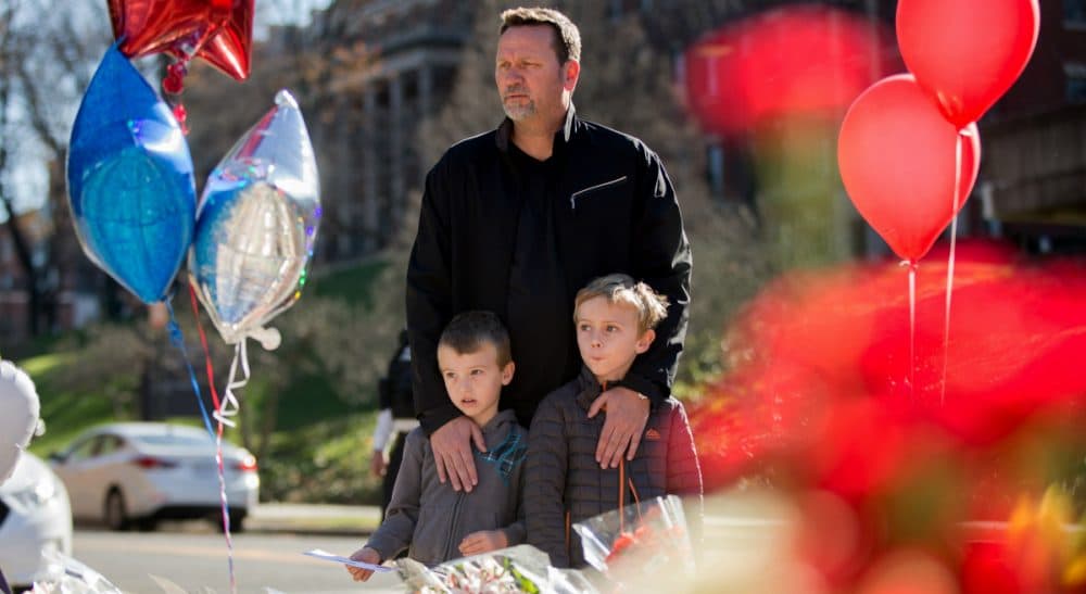 In this photo, James Jones of Woodbridge, Va., brings his two sons Riley, 7, and Grayson, 5, to a memorial outside the gates of the French Embassy in Washington, Sunday, Nov. 15, 2015. The Islamic State group claimed responsibility for Friday's attacks on a stadium, a concert hall and Paris cafes that left more than 120 people dead and over 350 wounded. (Andrew Harnik/ AP)