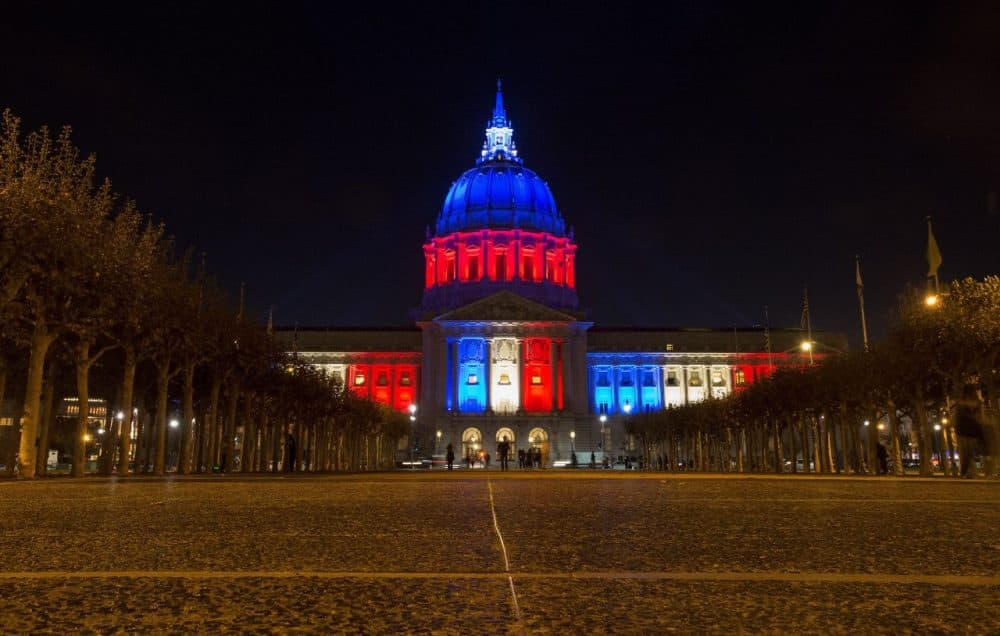 San Francisco's City Hall is illuminated in blue, white and red in San Francisco, California on November 14, 2015, one day after the Paris terrorist attacks. Stirring renditions of 'La Marseillaise' rang out from Dublin to New York as global landmarks were bathed in the French colors and thousands marched in solidarity with Paris after attacks that left at least 129 dead. (Josh Edelson/AFP/Getty Images)