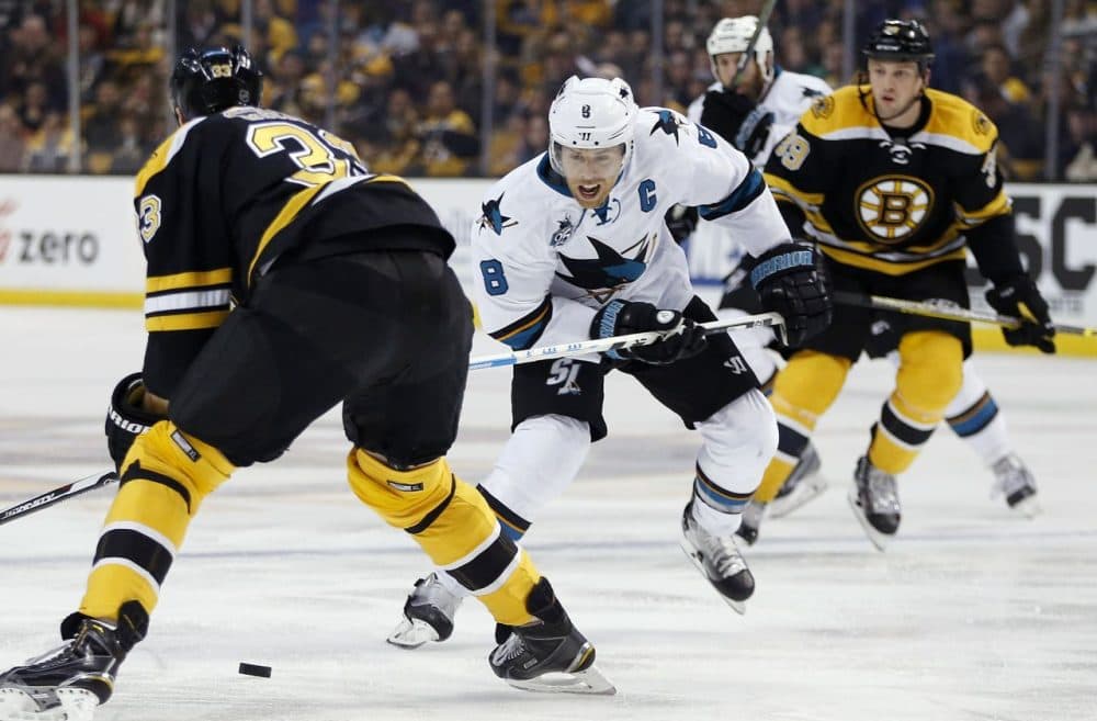 San Jose Sharks' Joe Pavelski (8) brings the puck up as Boston Bruins' Zdeno Chara (33) defends during the game last night in Boston. The Bruins lost, 5-4. (Michael Dwyer/AP)