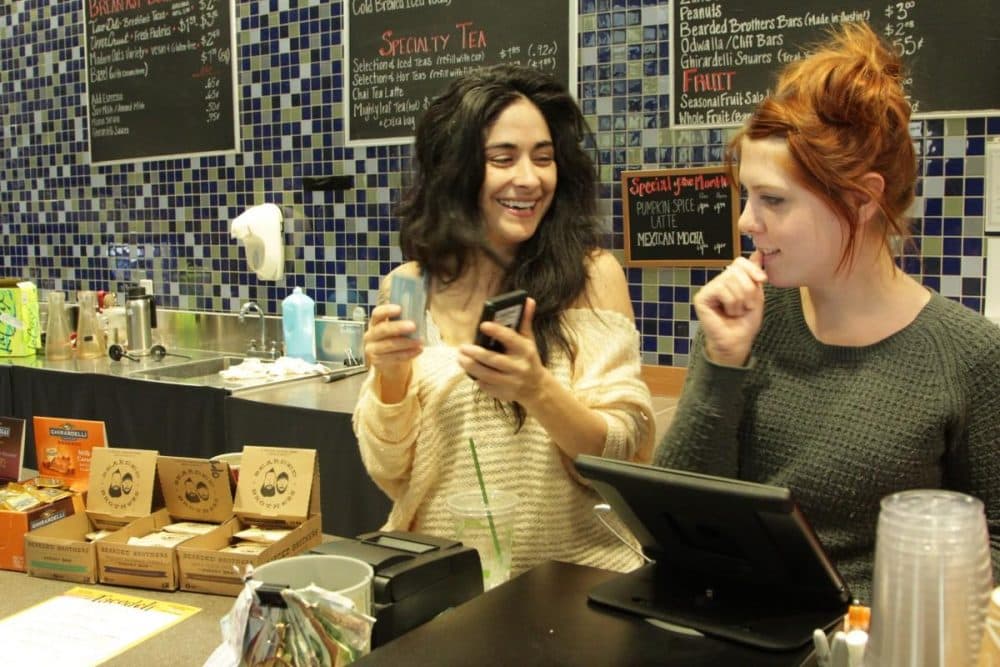 Baristas Sarah Castro (left) and Caitlyn Feeney take coffee orders at Cappy's. (Beth Cortez-Neavel/Texas Standard)