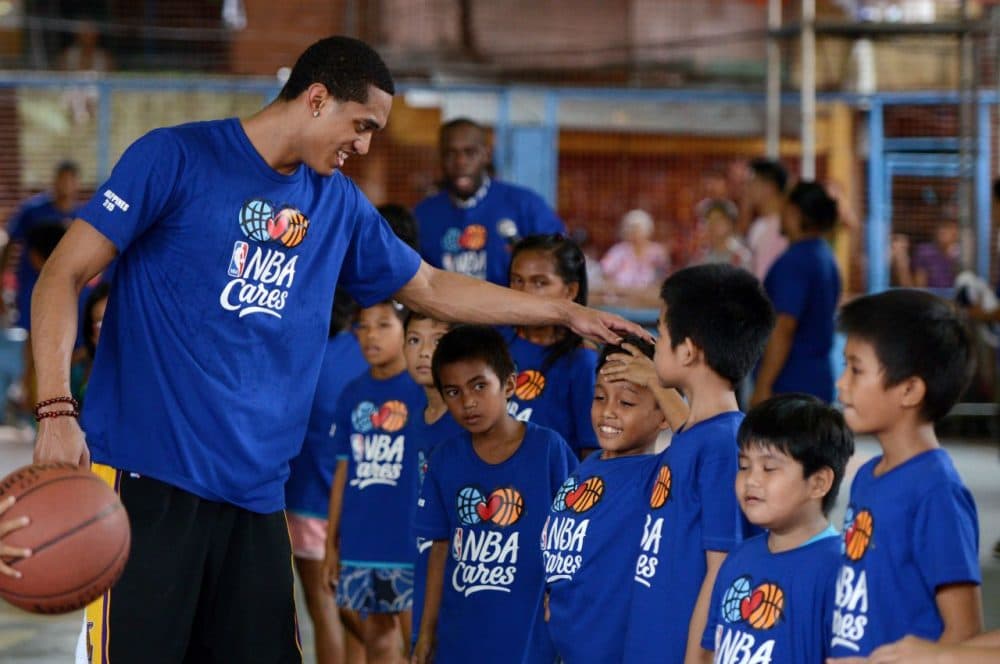 Programs like NBA Cares can make a difference, but experts say the real difference is made by coaches and mentors who work with the same kids over long periods of time.  (NOEL CELIS/AFP/Getty Images)