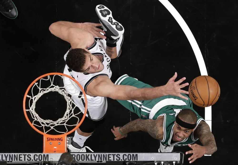 Boston Celtics guard Isaiah Thomas, right, shoots against Brooklyn Nets center Brook Lopez (11)  during the game in New York. The Nets won 111-101. (Julie Jacobson/AP)
