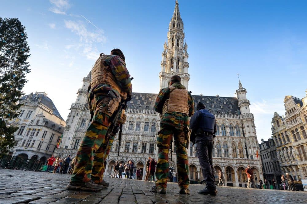 Soldiers and police patrol on Brussels' Grand Place as the Belgian capital remains on the highest possible alert level on November 23, 2015. Belgian police arrested five more people in a new series of anti-terrorism raids Monday, prosecutors said, as the capital Brussels was locked down for a third day under a state of maximum alert. (Dirk Waem/AFP/Getty Images)