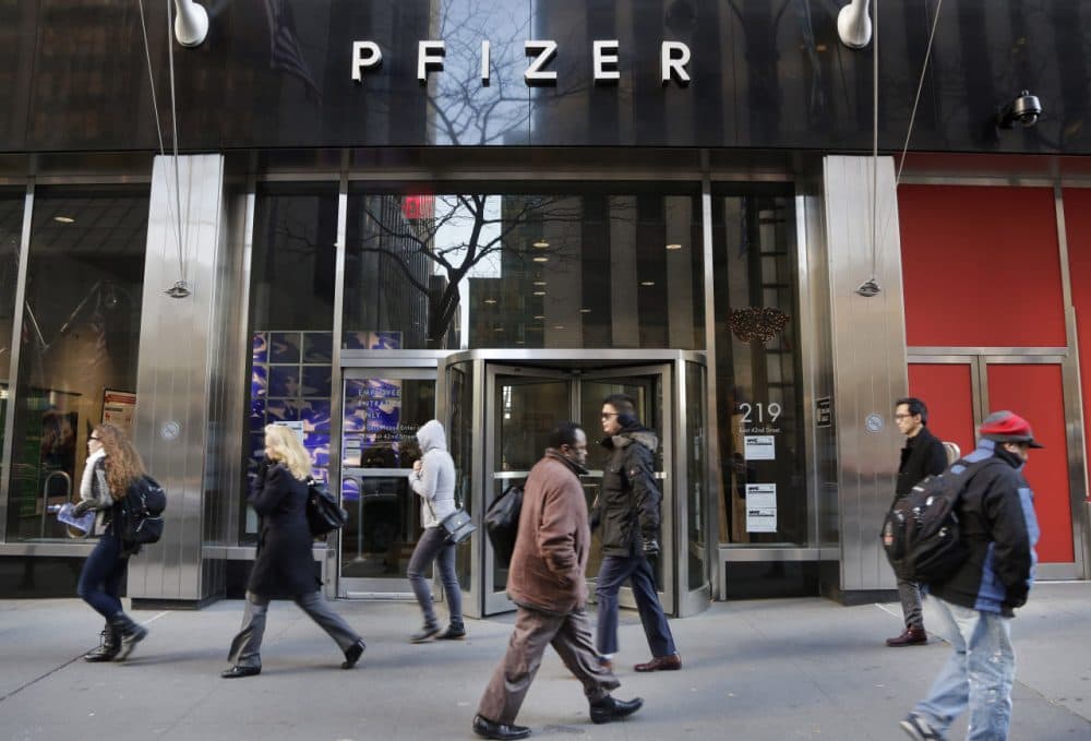 People walk past Pfizer's world headquarters, Monday, Nov. 23, 2015 in New York. Pfizer and Allergan will join in a $160 billion deal to create the world's largest drugmaker. (Mark Lennihan/AP)