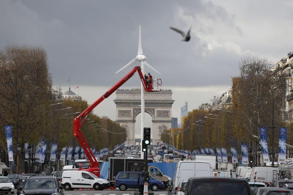 Workers install a wind turbine on the Champs-Elysees avenue on November 26, 2015 in Paris, ahead of the 21st Session of the Conference of the Parties to the United Nations Framework Convention on Climate Change (COP21/CMP11), also known as &quot;Paris 2015&quot; from November 30 to December 11.  (Patrick Kovarik/AFP/Getty Images)