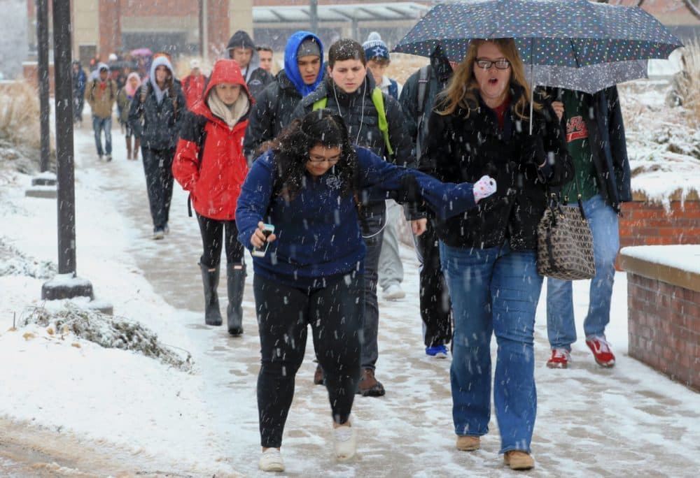 A student on the campus of the University of Nebraska at Omaha encounters a slippery pathway, in Omaha, Neb., Monday, Nov. 30, 2015. A slow-moving wintry storm system has been moving through parts of the Plains and the Midwest since Thursday. (Nati Harnik/AP)