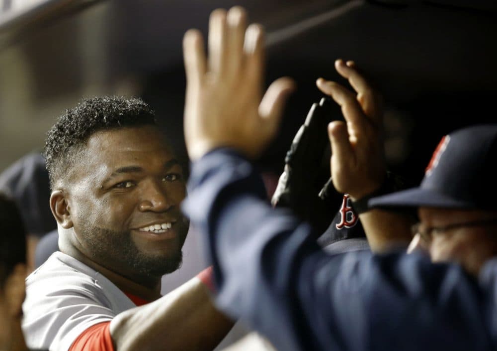 Red Sox's David Ortiz, left, greets teammates in the dugout in September 2015.  (Kathy Willens/AP)