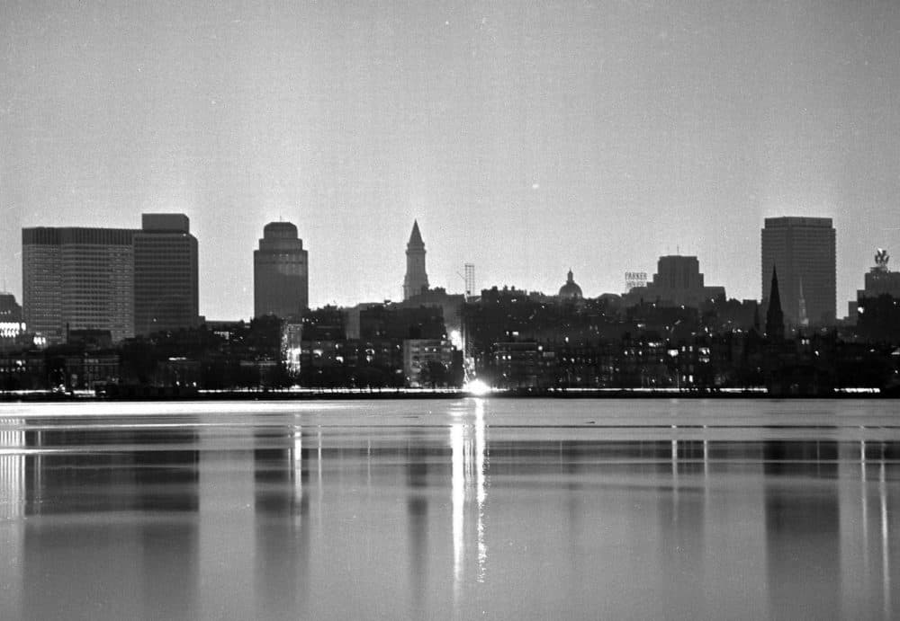 In this Nov. 9, 1965, file photo, the darkened Boston skyline is lit only by the full moon during a massive power failure that blacked out many sections of the Northeast and parts of Canada, 50 years ago. The two brightly lighted streets are on Beacon Hill, still lit by gaslight. (J. Walter Green/AP, File)