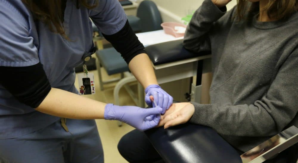 Michael Caron McGuill: &quot;Young people with their lives ahead of them are acquiring HIV at unprecedented rates. They deserve to know the facts.&quot; Pictured: 
An unidentified medical clinician, left, performs an HIV blood test on a patient at a Planned Parenthood location in Boston. (Steven Senne/AP)