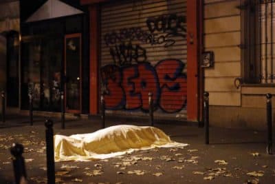 A victim outside the Bataclan theater in Paris. (AP Photo/Jerome Delay)