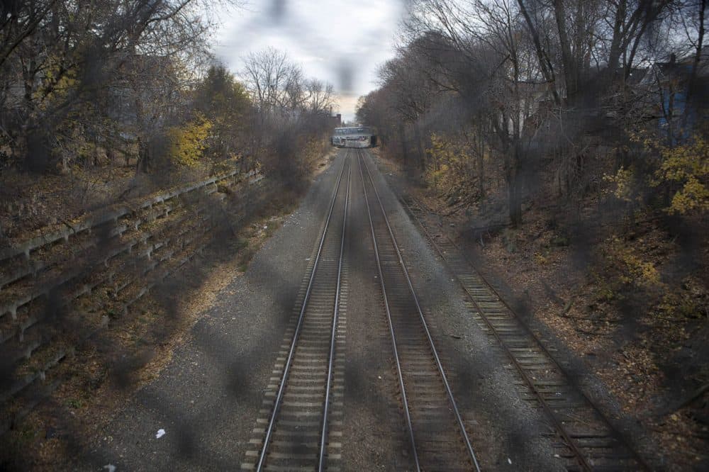 The tracks along the corridor for the proposed Green Line extension to Somerville and Medford already serve commuter rail and Amtrak trains. (Jesse Costa/WBUR)