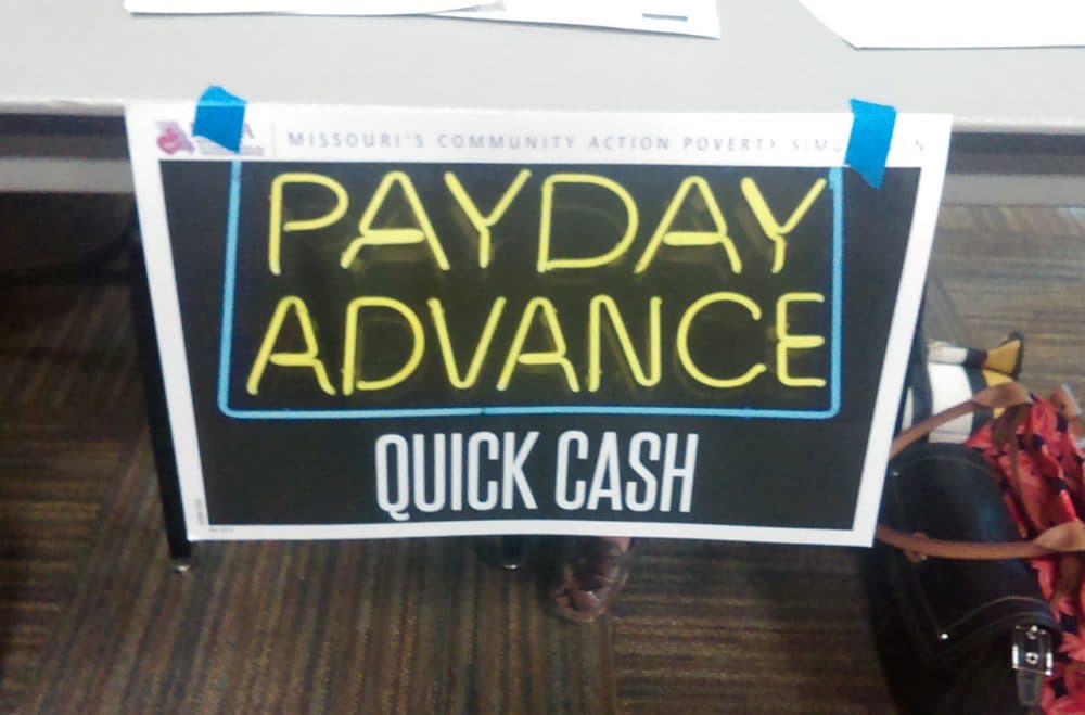 The poverty simulation included this &quot;payday advance&quot; table. (Gabrielle Ware/Georgia Public Broadcasting)