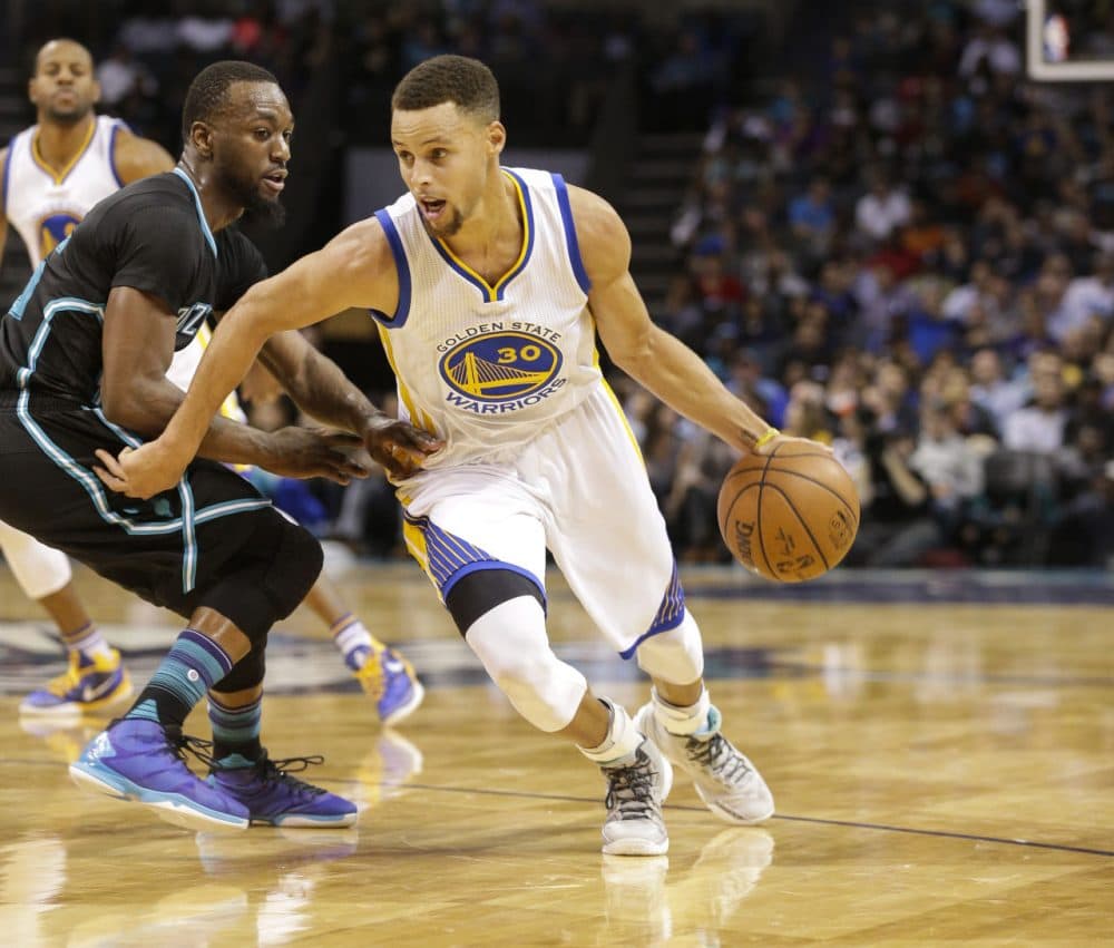 Golden State Warriors guard Stephen Curry, left, drives past Charlotte Hornets guard Kemba Walker in the second half of an NBA basketball game Wednesday, Dec. 2, 2015 in Charlotte, N.C. Golden State won 116-99. (Nell Redmond/AP)