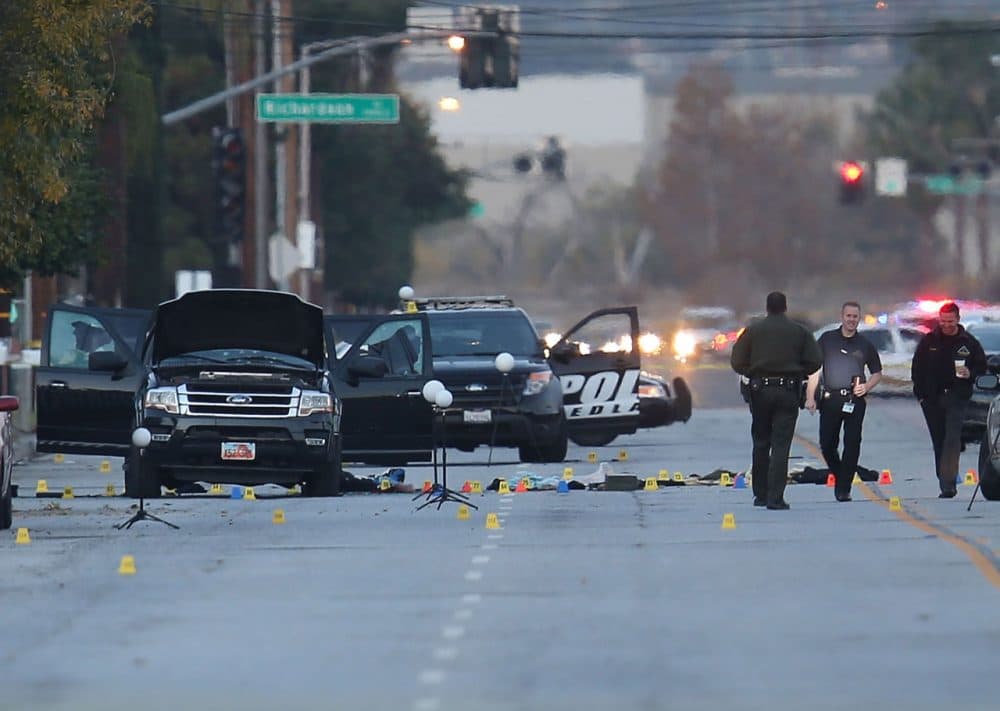 Law enforcement officials continue their investigation around the Ford SUV vehicle that was the scene where suspects of the shooting at the Inland Regional Center were killed on December 4, 2015 in San Bernardino, California. Police continue to investigate a mass shooting at the Inland Regional Center in San Bernardino that left at least 14 people dead and another 17 injured on December 2nd.  (Joe Raedle/Getty Images)