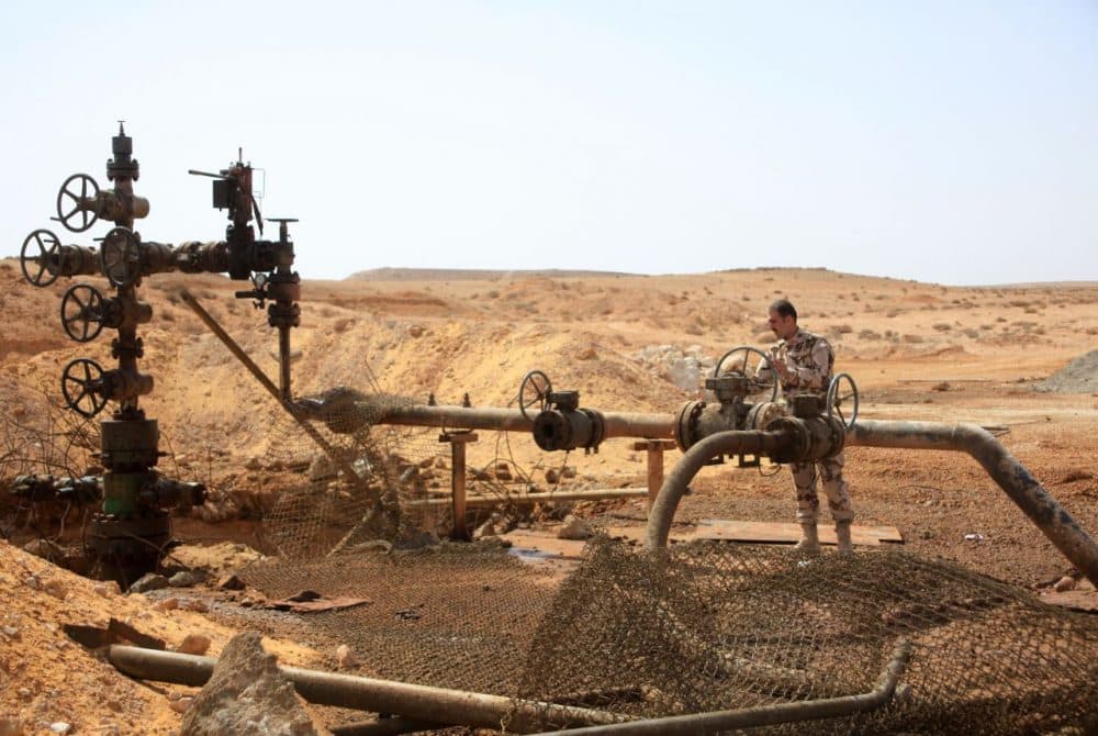 A member of the Syrian government forces stands next to a well at Jazel oil field, near the ancient city of Palmyra in the east of Homs province after they retook the area from Islamic State group fighters on March 9, 2015. Recent U.S.-led coalition airstrikes have frequently targeted oil facilities run by ISIS jihadists, who according to some estimates earn more than $1 million per day from oil sales. (STR/AFP/Getty Images)