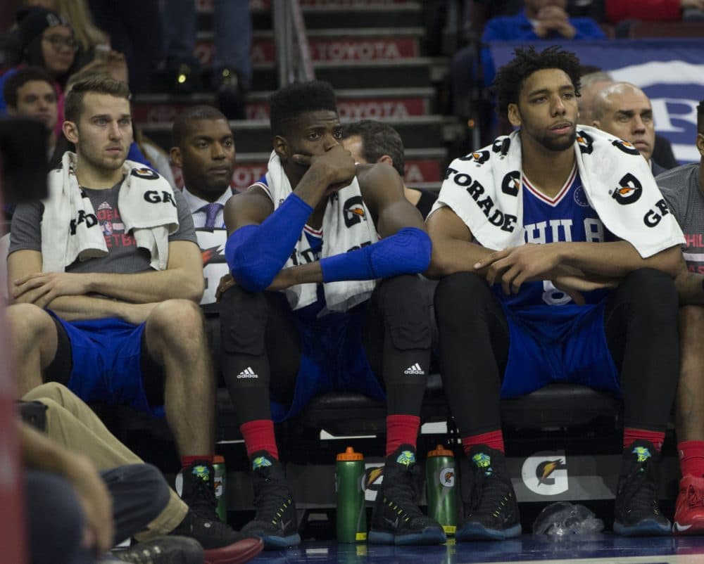 PHILADELPHIA, PA - OCTOBER 30: Nik Stauskas #11, Nerlens Noel #4, and Jahlil Okafor #8 of the Philadelphia 76ers watch the final minutes of the game against the Utah Jazz from the bench on October 30, 2015 at the Wells Fargo Center in Philadelphia, Pennsylvania. (Mitchell Leff/Getty Images)