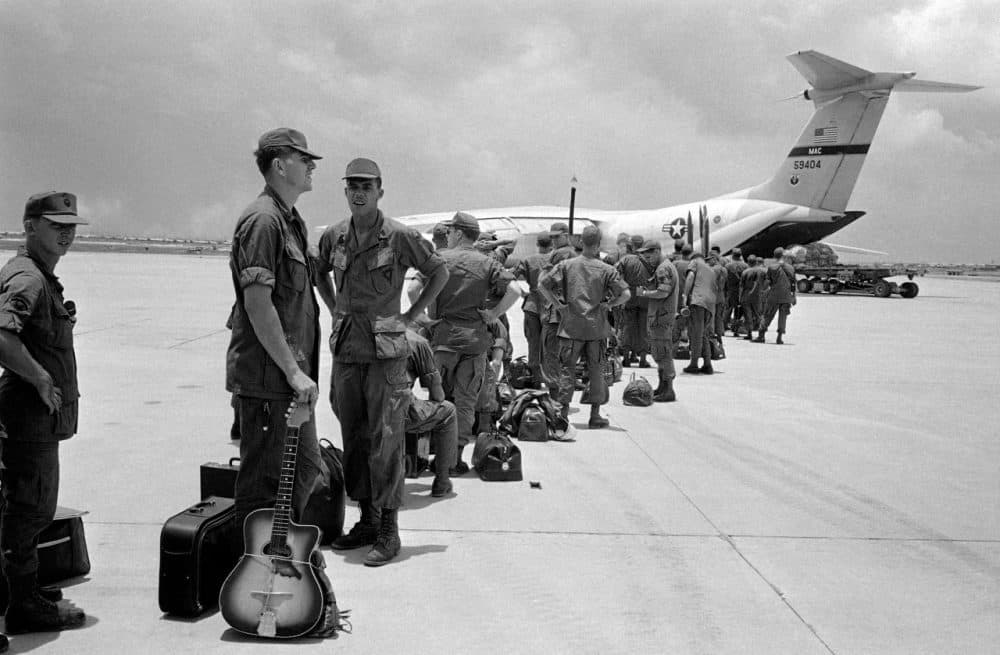 Some of the 300 troops of the 9th Infantry Division scheduled for departure from South Vietnam line up to board aircraft bound for Hawaii, August 27, 1969. (AP)