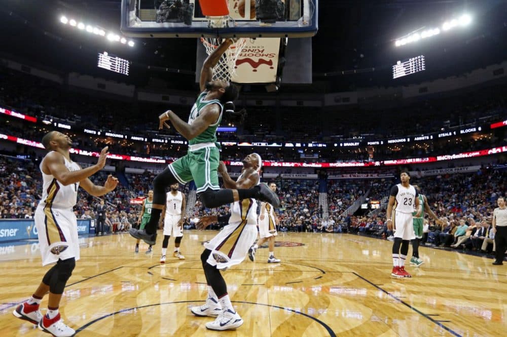 Boston Celtics forward Jae Crowder (99) drives to the basket in front of New Orleans Pelicans guard Eric Gordon, left,  and forward Dante Cunningham during last night's game in New Orleans. (Gerald Herbert/AP)